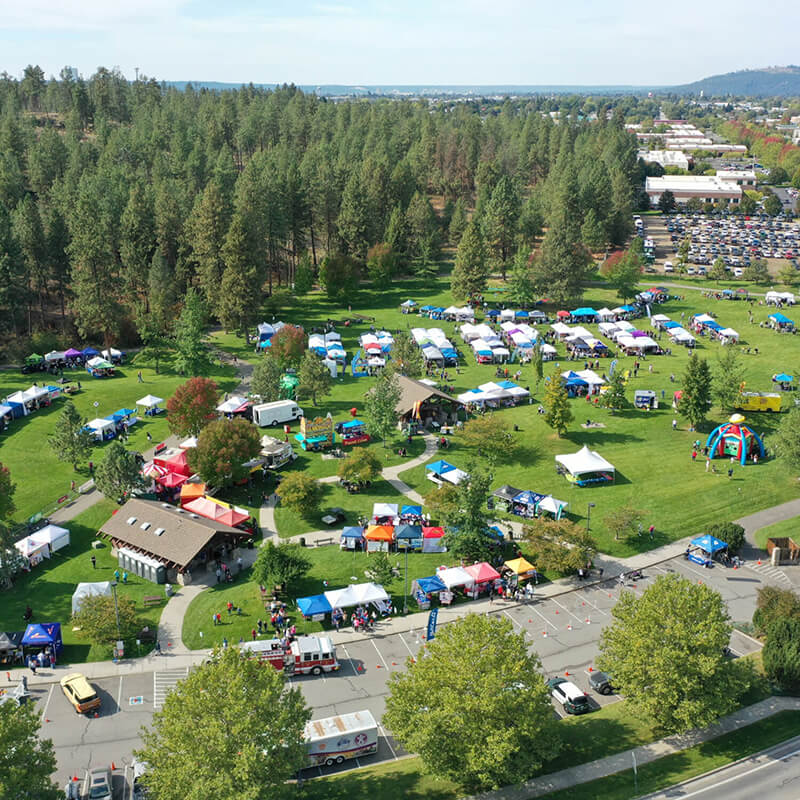 An aerial view of outdoor festival tents on a summer day.